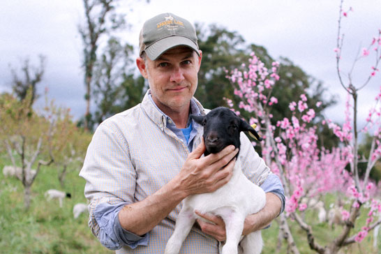 John Chester holding lamb