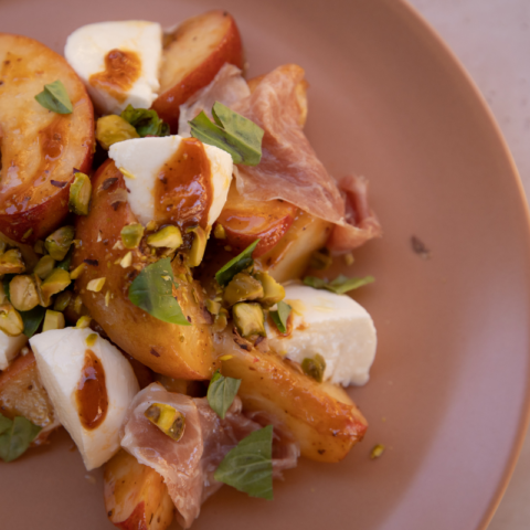 Peach, Prosciutto, and Fresh Mozzarella Salad with Strawberry-Harissa Vinaigrette